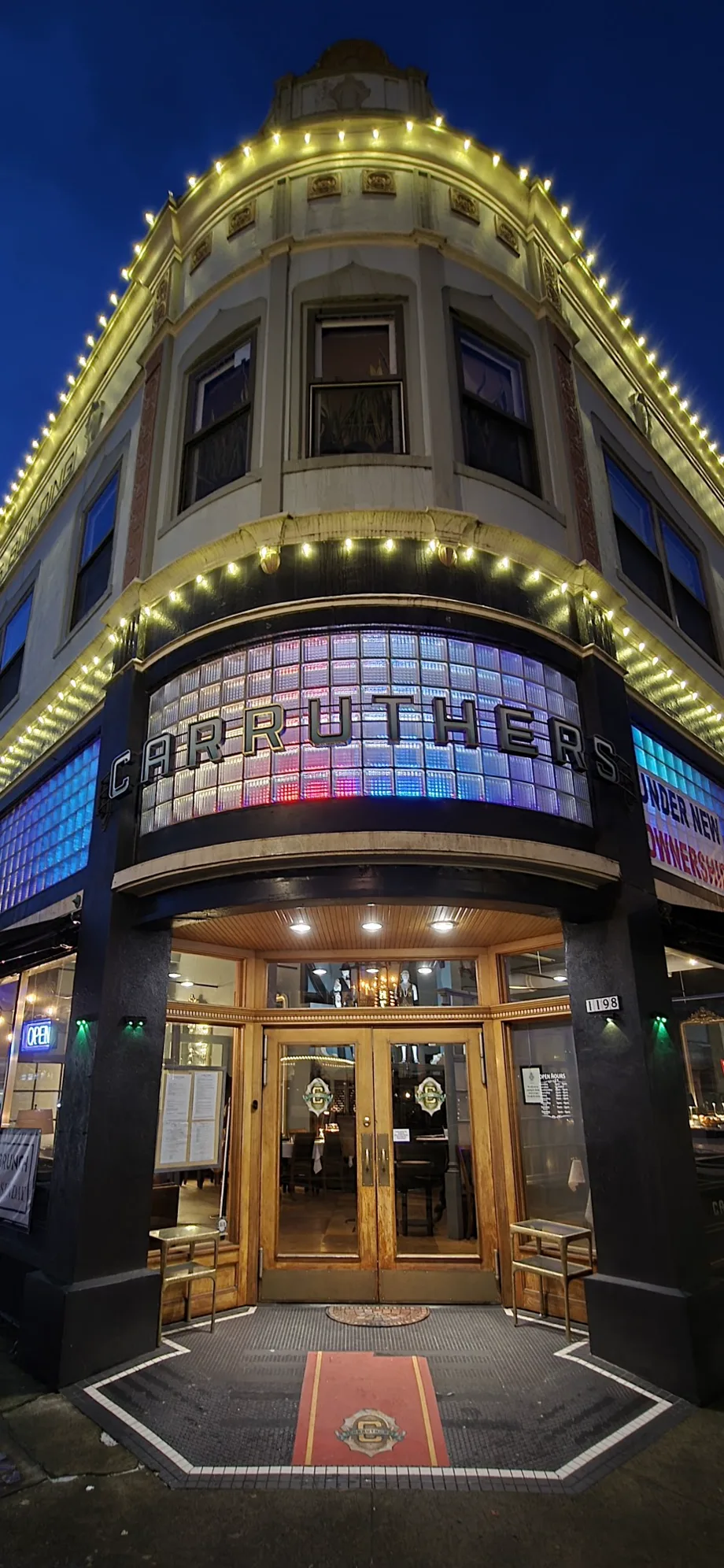 Carruthers entrance at night with the restaurant name and street number visible